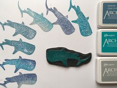 three rubber stamps with different types of fish on them and some type of magnets