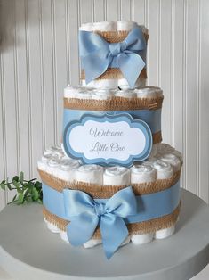 a blue and white diaper cake on top of a table