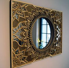 an intricately designed mirror hangs on the wall