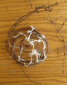 a bird's nest on a wooden table with twigs