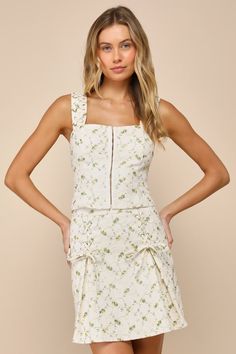 Spring sunshine and the Lulus Delightful Flirt Ivory Twill Floral Embroidered Mini Skirt will always make a perfect pair! Classic woven twill boasts adorable floral embroidery as it shapes this cute skirt that has a high, banded waist and godet-style pleats with sweet, lace-up bow details. Flaring mini hem completes the look. Hidden zipper/clasp at back. Pair with the matching top for a complete look! Fit: This garment fits true to size. Length: Mid-thigh. Size medium measures 17.5" from waist t Fitted Floral Embroidered Mini Skirt For Summer, Spring Floral Embroidered Fitted Mini Skirt, Fitted Floral Embroidered Mini Skirt For Spring, White Fitted Skirt For Garden Party, Fitted White Skirt For Garden Party, Money Skirt, Highschool Dance, Skirt With Pleats, Spring Sunshine