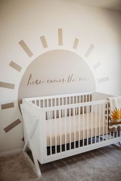 a white crib in front of a wall with the words keep coast here on it