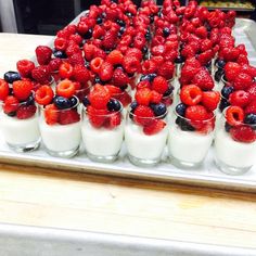 small glasses filled with fruit and yogurt on a tray