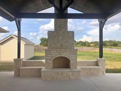 an outdoor fireplace in the middle of a patio