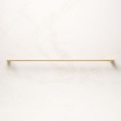 a white wall with a gold handle on it