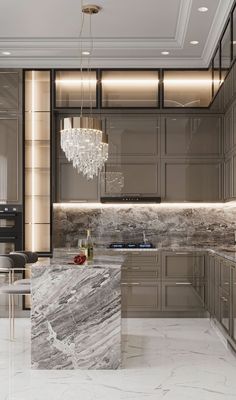 an elegant kitchen with marble counter tops and stainless steel appliances, along with chandelier