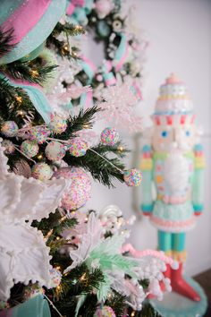 a christmas tree decorated with snowflakes and candy canes in front of a nutcracker ornament