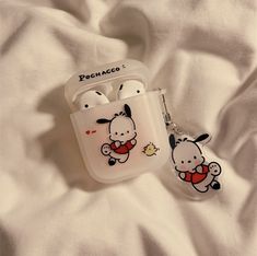 an airpods case with a cartoon character on it and a keychain attached to it