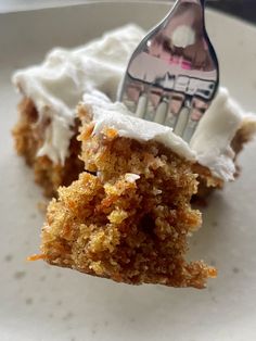 a piece of cake on a white plate with a fork in the middle of it