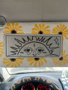 the dashboard of a car with sunflowers painted on it