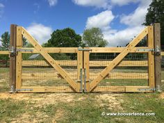 a wooden gate with wire around it