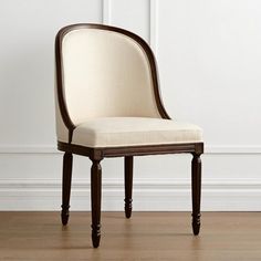 a white chair sitting on top of a hard wood floor