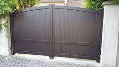 a large brown gate in front of a house