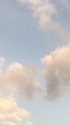 two airplanes flying in the sky with clouds