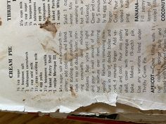 an old piece of paper that has been torn off and is sitting on a table