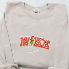 The Grinch Snow x Nike Embroidered Shirt is the perfect blend of style and holiday spirit. Made with high-quality materials, this shirt features an intricately embroidered Grinch design, adding a festive touch to any outfit. Its comfortable fit and durable construction ensure long-lasting wear. Give your loved ones the gift of warmth and style this Christmas with our Christmas Embroidered Sweatshirt. Crafted with care, this sweatshirt features a unique holiday-themed embroidery that will make a statement wherever you go. Made with soft and cozy fabric, it offers both comfort and style, making it an ideal gift for family members. Whether Nike Cartoon, Nike Inspired, Best Family Gifts, Maroon Hoodie, Shirt Nike, Hoodie Material, Nike Sweatshirts, Custom Nikes, Embroidered Clothes