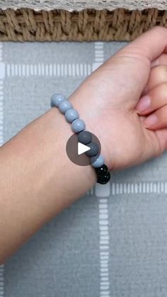 a person wearing a bracelet with beads on their wrist