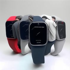 several different colored smart watches are arranged in a row, with one being held back by the other