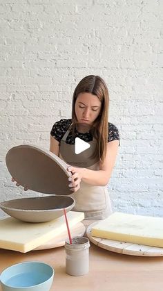 a woman in an apron is making some food