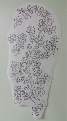 a piece of paper with flowers drawn on it hanging from the side of a wall