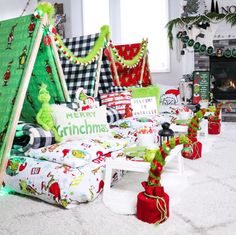 a living room decorated for christmas with presents on the floor and decorations around the fireplace