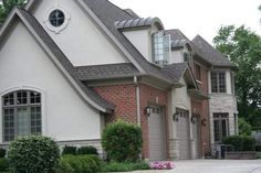 a large house with two garages and three windows