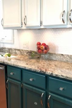 a bowl of fruit sitting on top of a kitchen counter