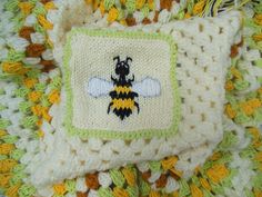 a crocheted square with a bee on it