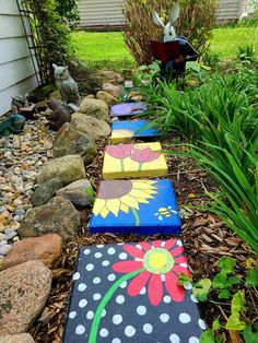 painted stepping stones are lined up in the garden