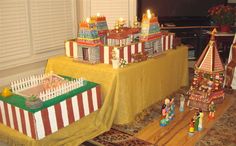 a table topped with miniature circus tents next to a window