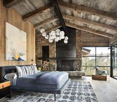 a living room filled with furniture and a fire place in the middle of an open floor plan