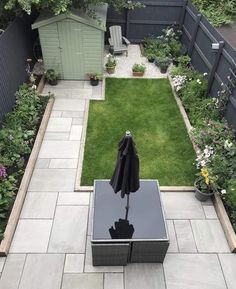 an umbrella is placed in the middle of a small garden