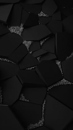 an abstract black and white photo with silver glitters on the surface that looks like hexagonal shapes