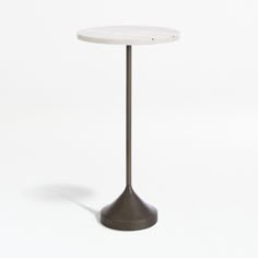 a white table with a metal base on a white background is seen in this image