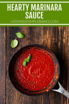 homemade hearty marinara sauce in a cast iron skillet with basil leaves on top