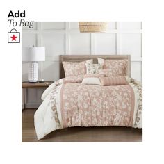 an image of a bed with pink and white comforter set on top of it