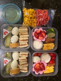 four plastic containers filled with different types of food