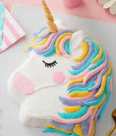 a cake decorated like a unicorn on top of a table