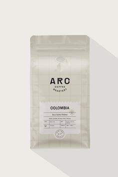 a bag of colombia coffee sitting on top of a white table