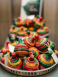 colorfully decorated cupcakes are sitting on a platter