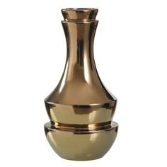 a gold vase sitting on top of a white table