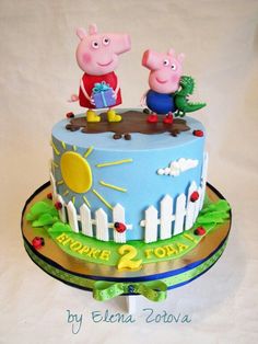 a birthday cake with peppa and george the pig on top