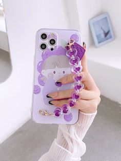 a woman holding up her phone case with an animal on it