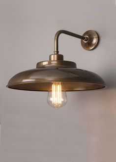 an old fashioned brass wall light with two bulbs