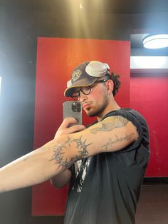 a man taking a selfie in front of a mirror with his arm wrapped around him