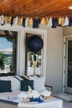 a living room filled with furniture and balloons