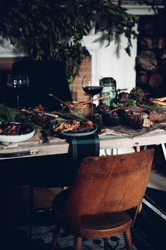 a table full of food and glasses of wine