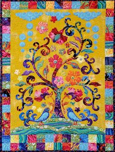 a quilted tree with colorful flowers and birds on the branches, in bright colors