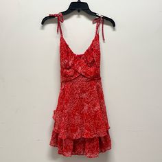 This Crystal Doll Mini Dress Is A Size Medium. V-Neck With Overlapping Material Detail At The Waist. Features Adjustable Spaghetti Straps With A Bow Accent, And An Attached Sash At The Waist. Has A Tiered Ruffle Design. Fully Lined. Brand New With Tags. Approximate Length From The Top Of The Chest Below The Strap Is 26 Inches. 100% Polyester. Cute And Fun Dress Perfect For The Summer. Chic Red V-neck Sundress, Red Tiered Mini Dress For Brunch, Red Tie Back Mini Dress For Summer, Red V-neck Dress With Tie Back, Casual Tiered Sundress For Party, Red Ruffled Sundress For Party, Red Tiered Mini Dress For Spring, Red Casual Mini Dress With Spaghetti Straps, Casual Red Mini Dress With Spaghetti Straps