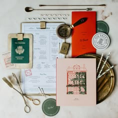 an assortment of items on a table including paper, scissors, and other things to do with them